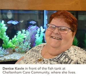 Denise Kavin in front of the fish tank at Cheltenham Care Community, where she lives.
