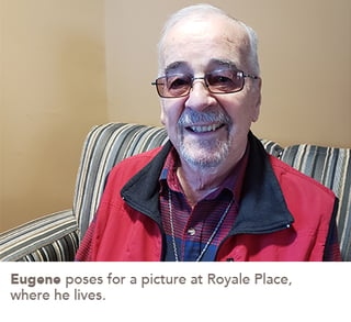 Eugene poses for a picture at Royale Place, where he lives.