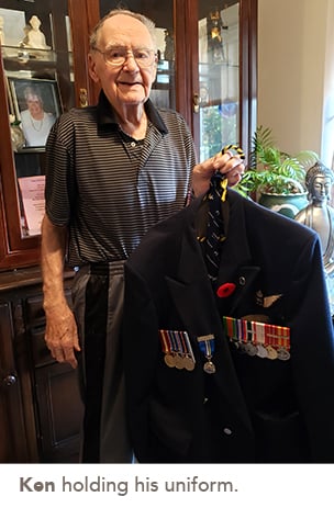picture of Ken holding his uniform