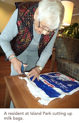 A resident cutting up milk bags