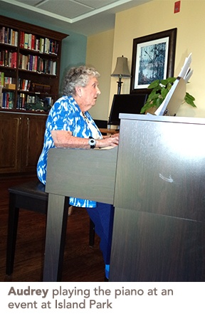 Audrey playing the piano at an event at Island Park