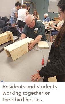 picture of residents and students working together on their bird houses