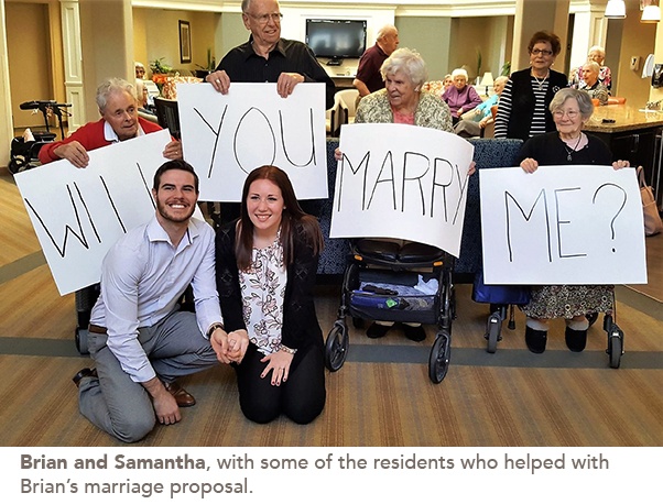 Photo of Brian and Samantha with some of the residents who helped with the marriage proposal