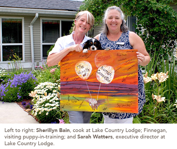 Left to right: Sherillyn Bain, cook at Lake Country Lodge; Finnegan, visiting puppy-in-training; and Sarah Watters, executive director at Lake Country Lodge. 